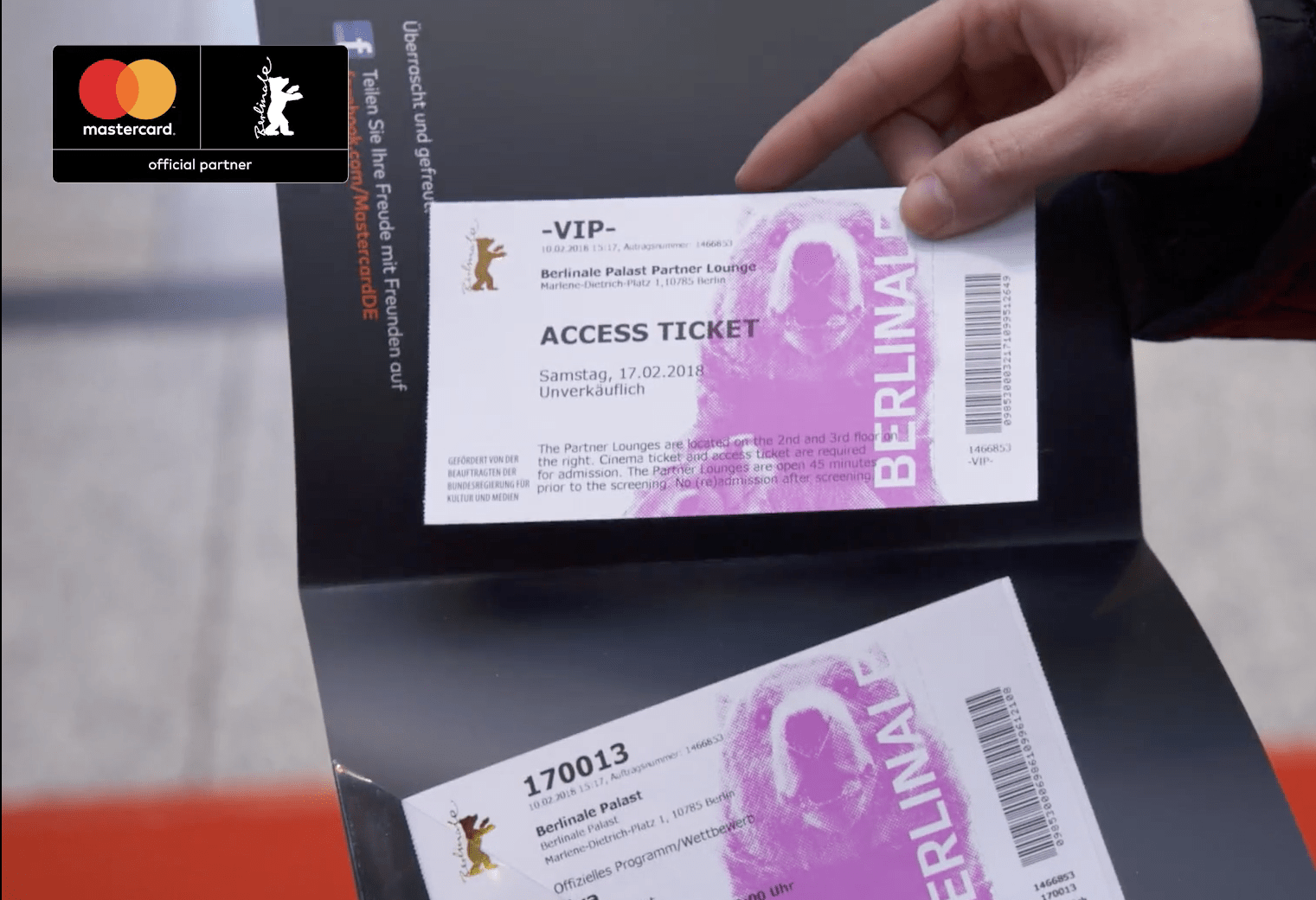hand holding berlinale access tickets