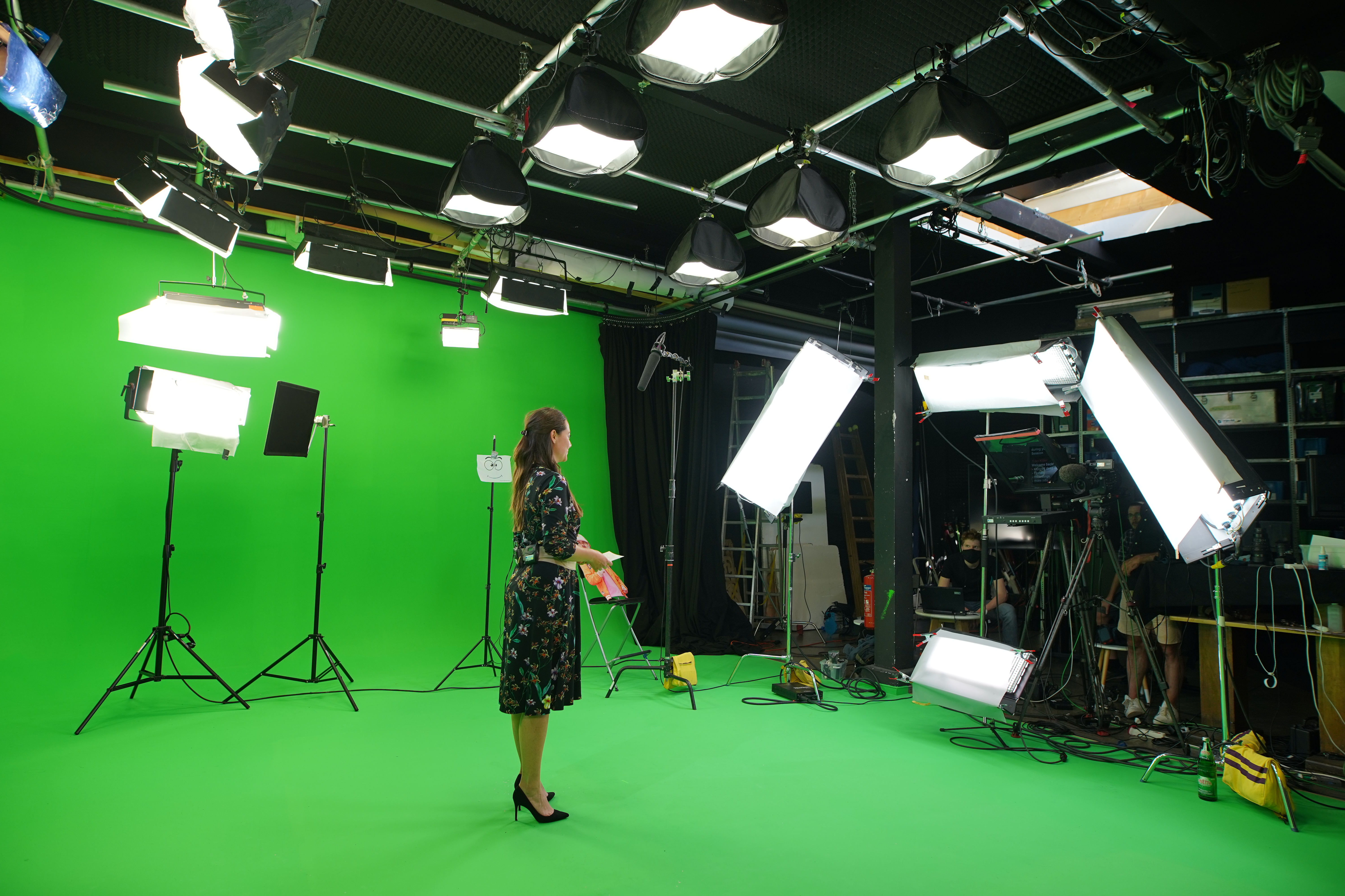 woman being recorded on a greenscreen studio
