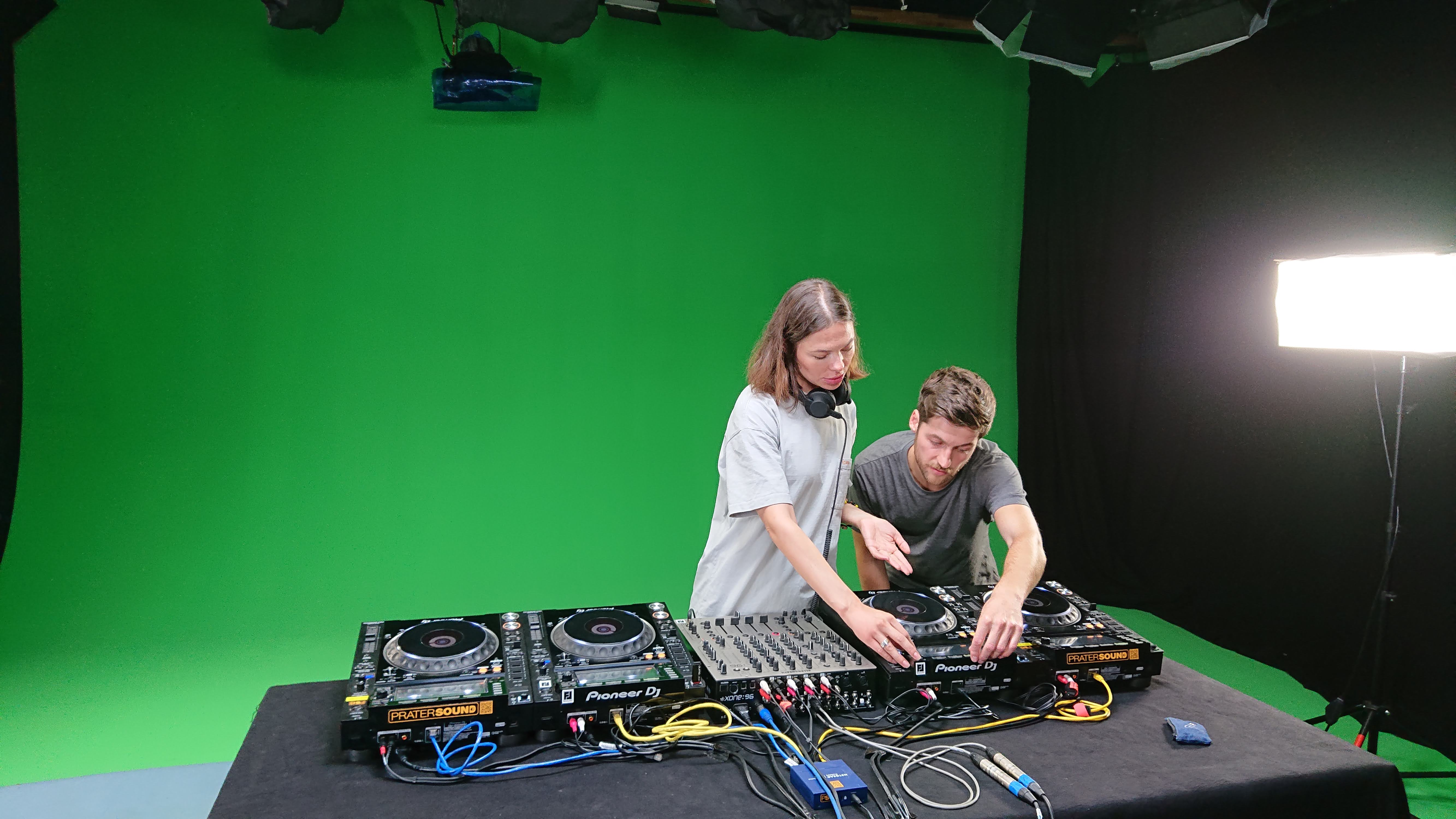 two men with sound equipment in front of a Greenscreen Studio